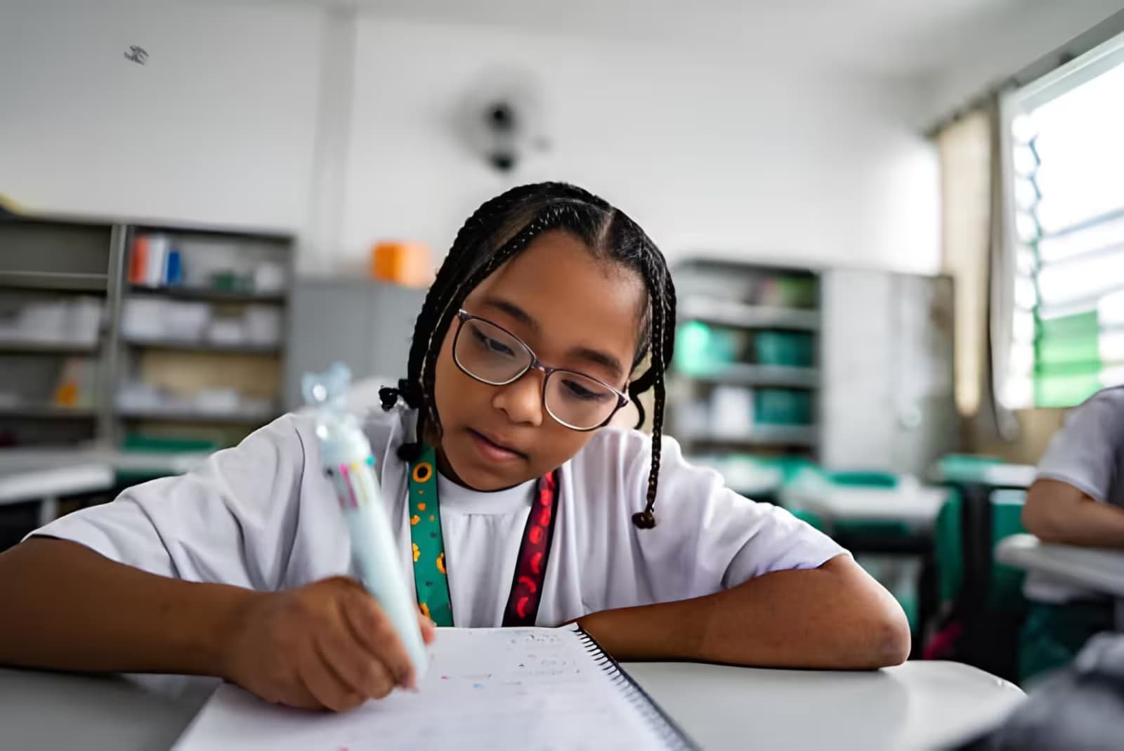 Student completing classwork at her desk