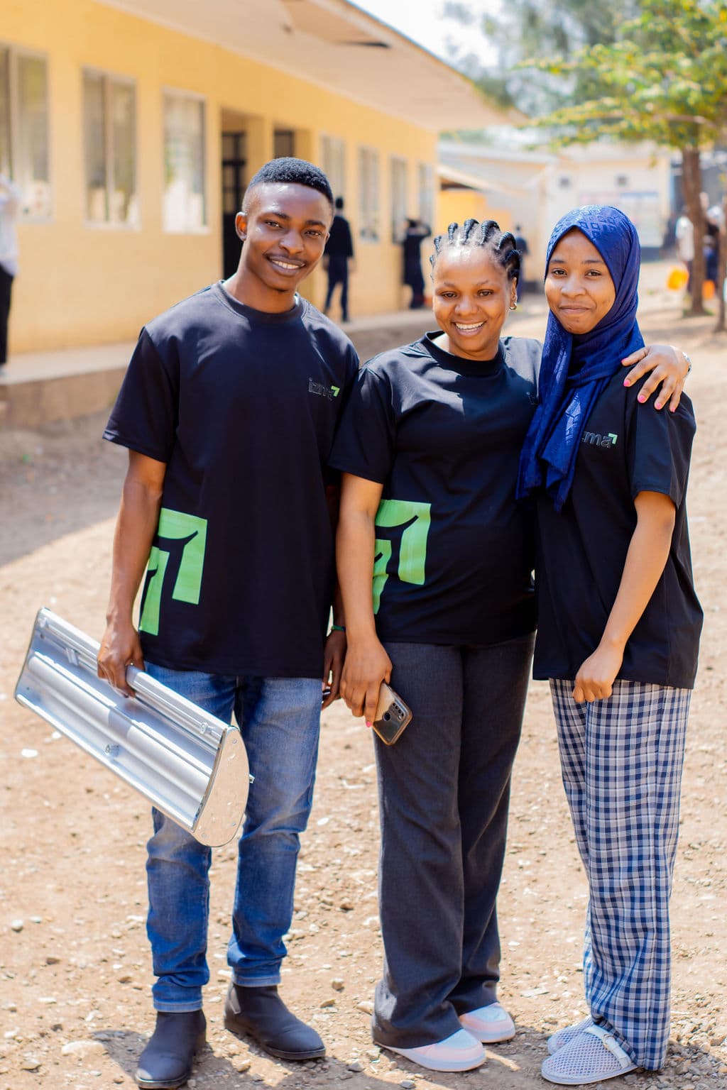 Three Izma team members standing together outdoors